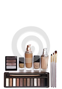 Cosmetics in natural colors and brushes. Makeup tools and accessories. Brow eyeshadows, naturel skin foundation