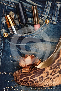 Cosmetics and perfumery sticks out of the pocket of his jeans