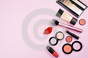 Cosmetics is on the pink backgroud. Makeup in close view. A lot of Cosmetics for woman on the background photo