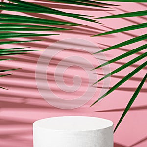 Cosmetics product advertising stand. Exhibition white podium with geometric shapes on a pink background with palm leaves and