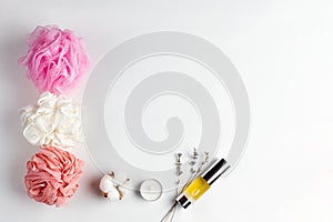 Cosmetics and self-care. Composition of washcloths, oil in a tube, dry lavender and candle on a white background. Copy space and