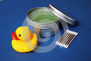 Cosmetics set: rubber duck, body scrub in a jar, bamboo cotton sticks