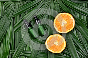 Cosmetics skincare with vitamin-c extract, Cosmetic dropper bottle containers with fresh orange slices.