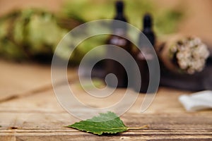 Cosmetics for spa treatments and baths on a wooden table with a birch broom.Blurred background