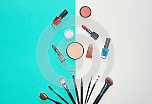 Cosmetics white and blue background with make up artist objects: lipstick, eye shadows, mascara ,eyeliner, concealer, nail polish.