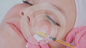 cosmetological injections in face skin of female client of beauty clinic, closeup view, mesotherapy