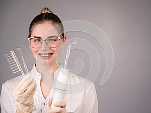 The cosmetologist doctor holds the darsonval device with different nozzles.