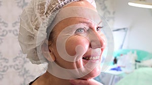 Cosmetologist doctor prepares female face for a cosmetic injection , injections of hyaluronic acid. Woman in a beauty