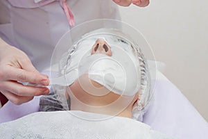 A cosmetologist does an ultrasonic cleaning of the skin of the face