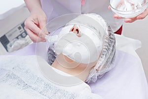 A cosmetologist does an ultrasonic cleaning of the skin of the face