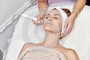 cosmetologist doing anti aging procedure in salon