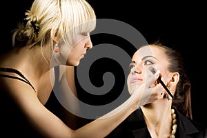 Cosmetologist doing make-up photo