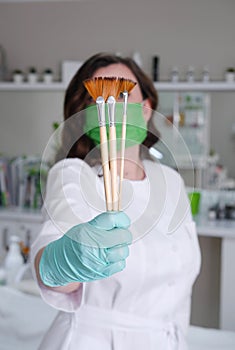 Cosmetologist with Fan Brushes for Facial Treatments