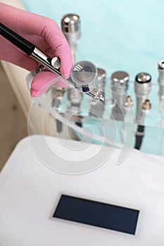 Cosmetologist Hand Holding Skincare Machine Attachment