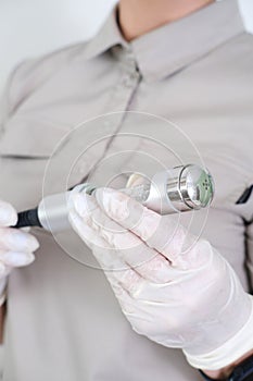 Cosmetologist holding a device attachment