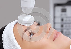 The cosmetologist makes the apparatus a procedure of Hardware face cleaning with a soft rotating brush