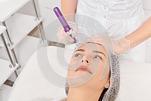 Cosmetologist makes mesotherapy injection for rejuvenation woman face, procedure in beauty salon