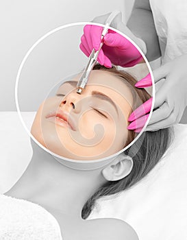 The cosmetologist makes the procedure Microdermabrasion of the face skin of a beautiful girl in a beauty salon.Cosmetology and