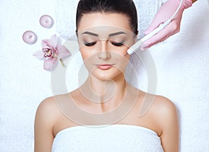 The cosmetologist makes the procedure treatment of Couperose of the facial skin photo