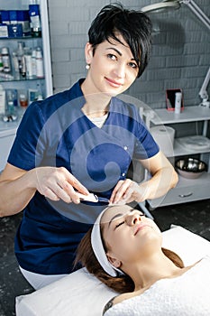 Cosmetologist makes procedure of ultrasound cleaning