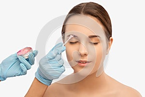Cosmetologist makes rejuvenating anti wrinkle injections on the face of a beautiful woman. Female aesthetic cosmetology in a