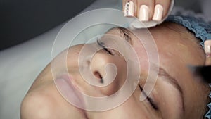 Cosmetologist makes ultrasonic cleansing facial