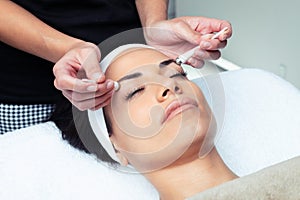 Cosmetologist making the eyes contour therapy for rejuvenation to woman on the spa center
