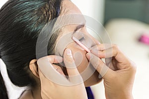 Cosmetologist making permanent makeup on face woman`s, woman plu