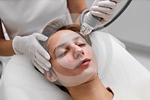 A cosmetologist performs hydropiling in a beauty salon. Skin care.