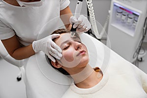 A cosmetologist performs hydropiling in a beauty salon. Skin care.