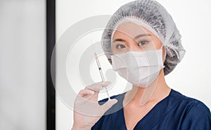 Cosmetologist wear face mask and holding injection syringe for preparing to face augmentation for anti wrinkle in beauty clinic