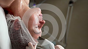 Cosmetologist working with woman's face while procedure ultrasound cavitation, facial peeling