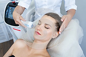 Cosmetology. Beautiful woman getting laser hair removal procedure in beauty