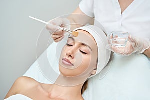 Cosmetology beauty procedure. Young woman skin care.