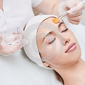 Cosmetology beauty procedure. Young woman skin care.