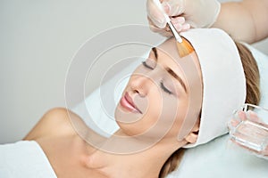 Cosmetology beauty procedure. Young woman skin care.