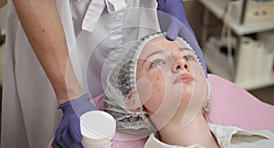 Cosmetology Clinic. Close-up of the face of a young teenage girl with problem skin, rashes and pimples on the face. The