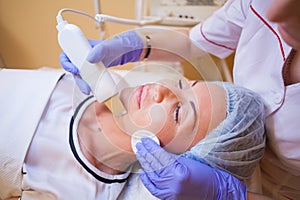 Cosmetology doctor makes the procedure a woman face cleaning