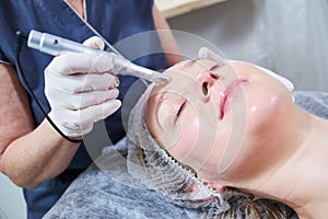 Cosmetology. female facial skin beauty procedure in salon