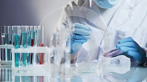 Cosmetology lab assistant preparing organic substance for anti-aging cream