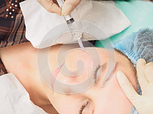 Cosmetology procedure mesoteraphy. Rejuvenation revitalization, skin nutrition, wrinkle reduction. Doctor making microneedle injec photo