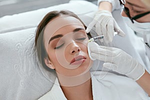 Cosmetology Procedure. Woman Receiving Face Skin Lift Injections