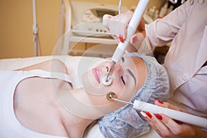 Cosmetology Spa woman doing procedures on the face