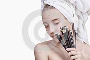 Cosmetology visage wellness concept.Girl with cosmetic brushes. Face care. Cosmetic procedures