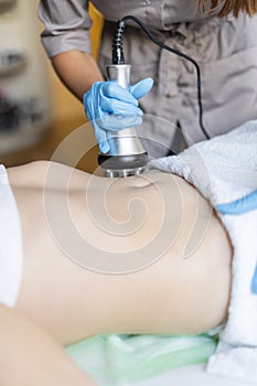 Cosmetology. A woman in a spa clinic receives an RF lifting procedure