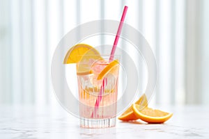 cosmo with pink paper straw, softfocus citrus fruit slices, light background