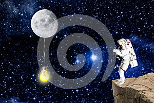 Cosmonaut and moon lighting universe.mission in outer space photo