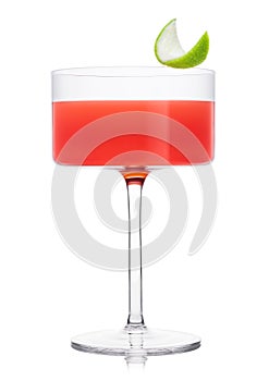 Cosmopolitan cocktail in modern crystal glass with lime peel on white