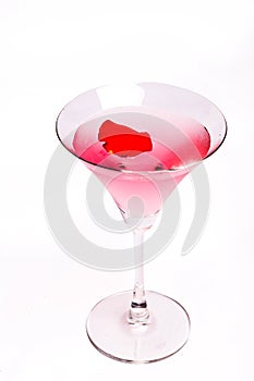 Cosmopolitan cocktail with rose in top of a white