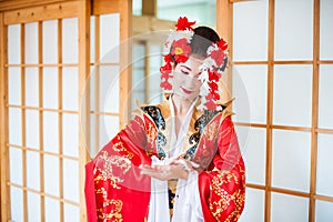 Cosplay. beautiful, modest geisha in a red kimono